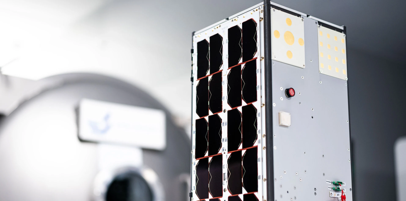 Close-up view of a 16 cubesat with integrated solar panels prepared for laboratory testing