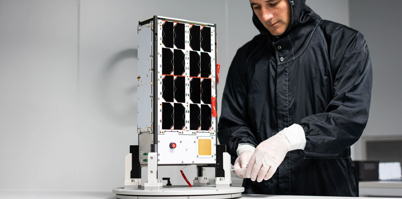 Engineer assembling EnduroSat 8u cubesat with integrated solar panel modules