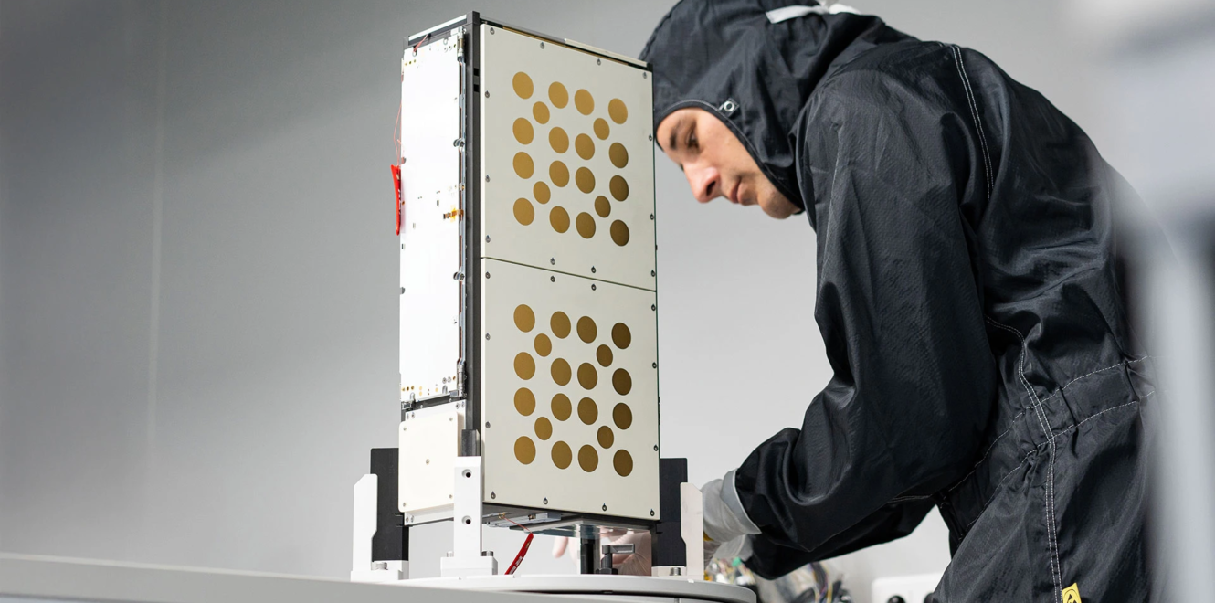 Engineer inspecting EnduroSat 8u cubesat during assembly in clean room