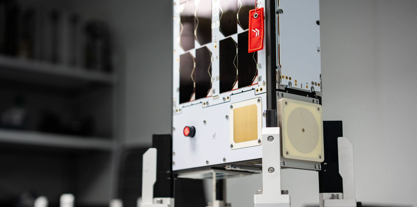 EnduroSat 8u cubesat mounted on test stand with visible payload and antenna panels