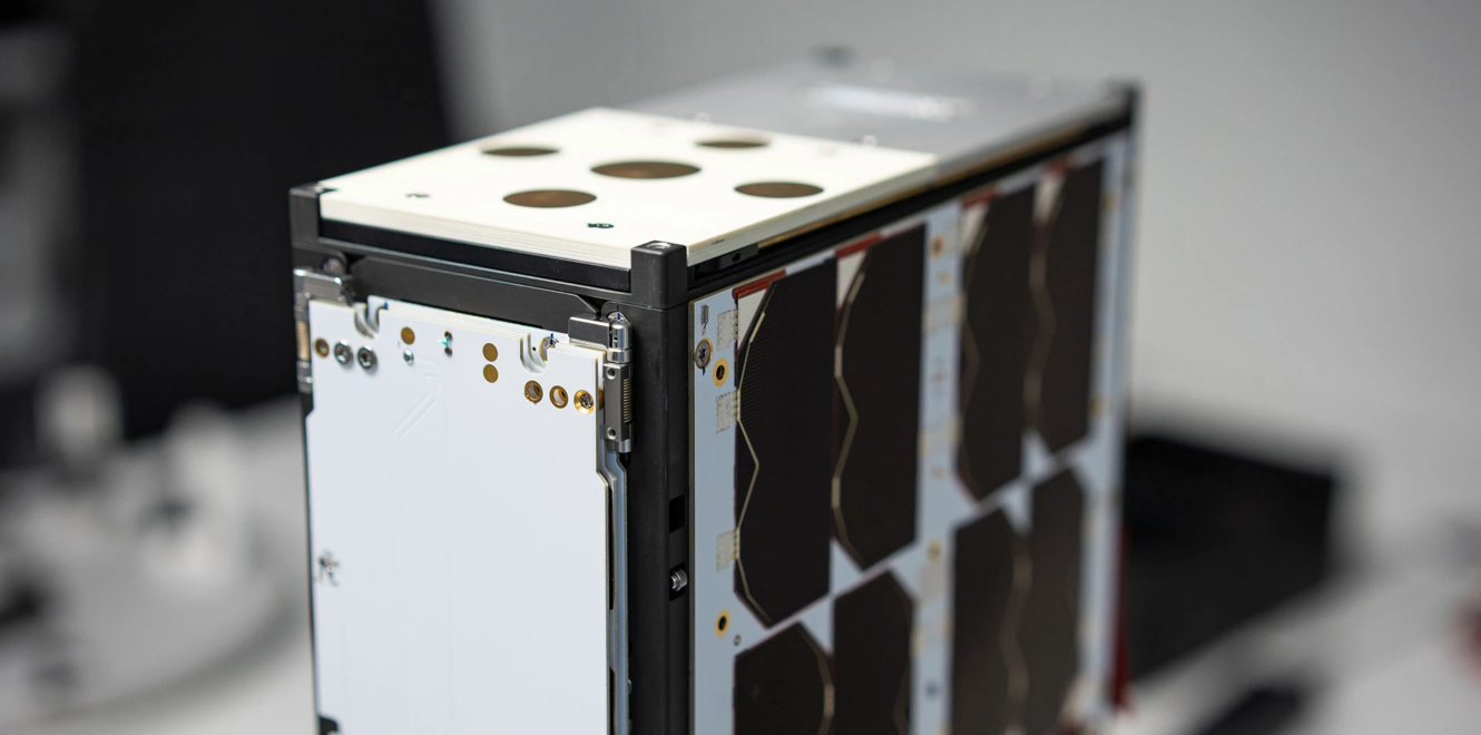 Detailed view of 8u cubesat assembly showing panel mounts and connectors